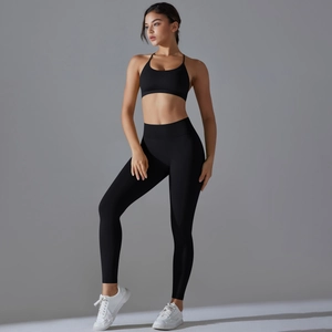 Side view of seamless black yoga set with high-waist leggings and cross-back sports bra
