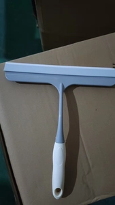 Detail view of manual non-slip glass squeegee with grey and white silicone blade