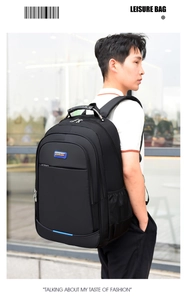 Side view of a man carrying a large black business travel backpack in an urban setting