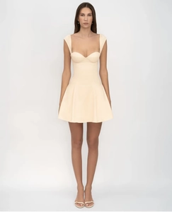 Detailed view of the yellow mini dress with a flared skirt and thin shoulder straps