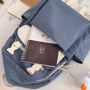 Blue student backpack with multi-pocket design, off-white straps and a cute duck pendant