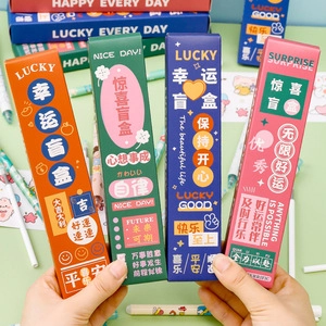 Close-up of four colorful lucky blind boxes with positive slogans for student stationery
