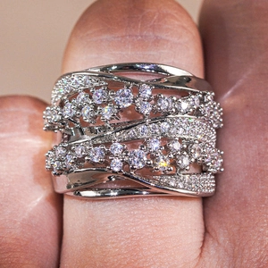 Macro view of multi-layer crisscross silver ring with shimmering zircon stones