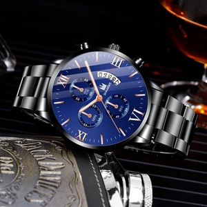 Business men's watch detail with blue sunray dial and black steel strap near whiskey