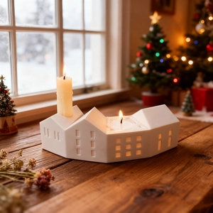 White ceramic house candle holder with cutout windows for cozy Nordic holiday home decor