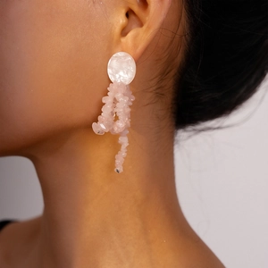 Elegant drop earrings featuring white circular studs and pink stone tassel pendants