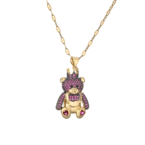 Golden crown bear necklace with pink and purple rhinestones on a polished flat link chain