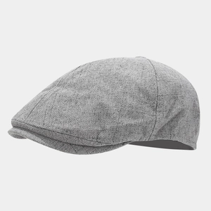 Detailed view of light grey linen newsboy cap showing textured fabric and stitching