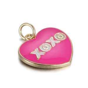 Detailed view of pink enamel heart pendant with golden edges and XOXO engraving