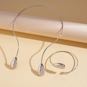 Detailed view of silver droplet choker and spiral cuff bracelet with mirror finish