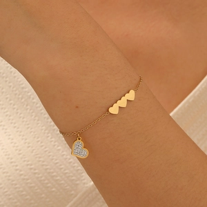 Gold-plated stainless steel bracelet with three solid hearts and one crystal heart charm