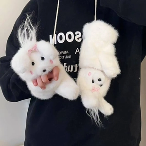 Close-up of white plush dog neck pouch with pink bow on black hoodie background