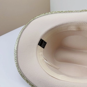 Close-up of cotton-polyester fabric interior and inner sweatband with gold trim