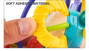 Close-up showing the soft adhesive material of the Manhattan ball being squeezed