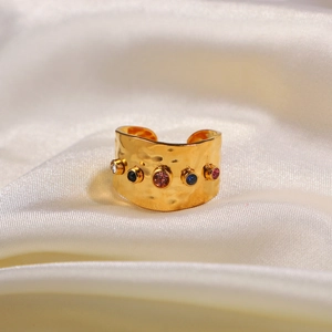 Detail of 18K gold plated wide ring with hammered texture and colorful zircon stones