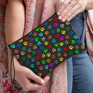 Black cosmetic bag with colorful paw prints featuring a metal zipper and wrist strap