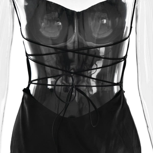 Detail of cross-back lace-up design on a black slit evening dress with thin straps