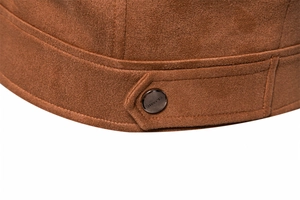 Detailed close-up of brown suede jacket hem with a classic metal button fastener