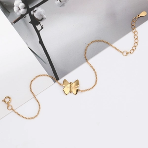 Detailed shot of golden butterfly bracelet with adjustable extender chain and drop charm