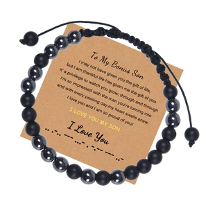 Detail of Morse code beaded bracelet with black matte stones on I Love You card