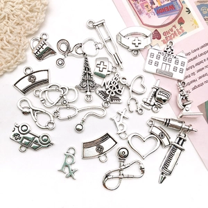 Detailed macro view of assorted silver medical-themed alloy charms for DIY jewelry making