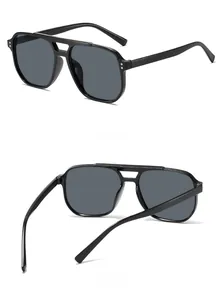 Détail des lunettes aviateur à double pont avec rivets en métal et verres gris