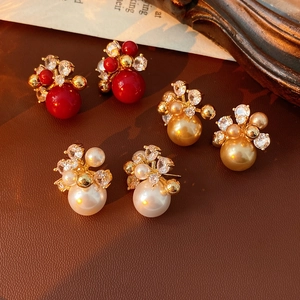 Detailed close-up of vintage flower earrings with pearls and zircons on leather
