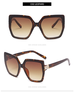 Detailed view of leopard print cat-eye sunglasses with rhinestone hinges and gradient lenses