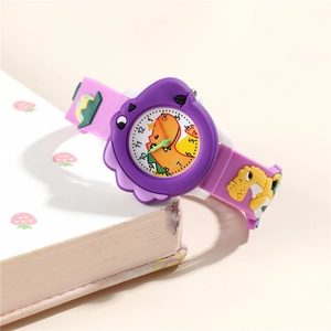 Macro detail of purple kids cartoon watch with 3D dinosaur silicone strap and clear dial