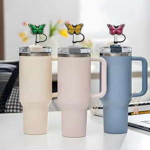 Detail of tumblers with butterfly straw toppers and matching charms for party supplies