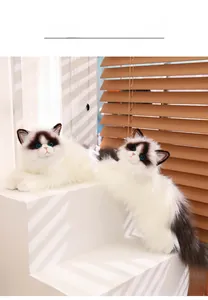Detailed plush ragdoll cat doll with soft long-hair fur and realistic blue glass eyes