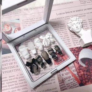 Exquisite black and white press-on nails with 3D bows and pearls in a display box