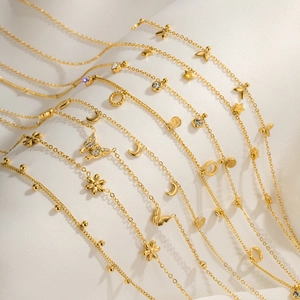 Detailed view of assorted gold thin chain necklaces with butterfly and floral charms