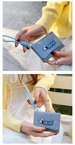 Blue denim tri-fold wallet with cartoon embroidery and matching woven lanyard