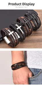 Detail of multi-layer braided leather bracelet featuring a cross charm and magnetic clasp