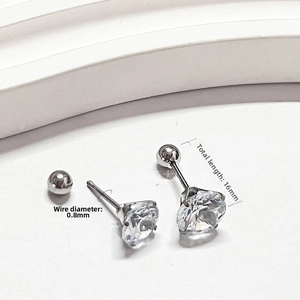 Detailed macro view showing 0.8mm gauge stainless steel stud earrings with clear zircon
