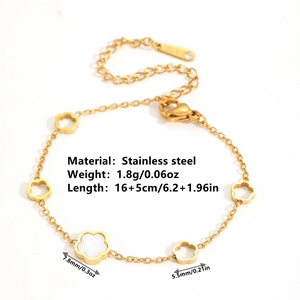 Detail view of golden stainless steel bracelet with cutout flowers and lobster clasp
