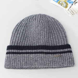 Detail view of grey ribbed knit beanie with blue stripes and sport metal tag