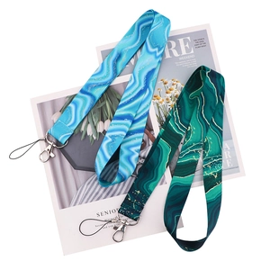 Detail of blue and green marble patterned lanyards with metal clasps and gold accents