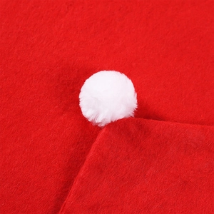 Creative red felt Christmas hat chair cover with a soft white plush pom-pom detail