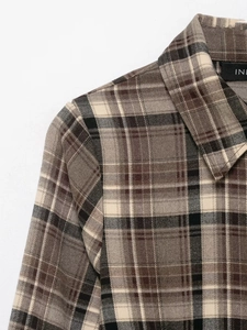 Detail view of the classic plaid shirt collar and shoulder tailoring in cotton fabric