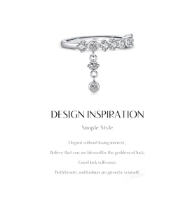 Macro detail of S925 sterling silver ring featuring a dangling tassel charm and cubic zirconia