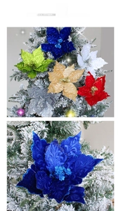 Detail of glittered velvet Christmas flowers in various colors on a snowy tree branch