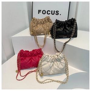 Detailed view of quilted bucket bags in various colors with golden chain straps
