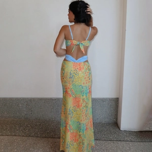 Detail of the tie-back design on the backless top with colorful abstract print maxi skirt