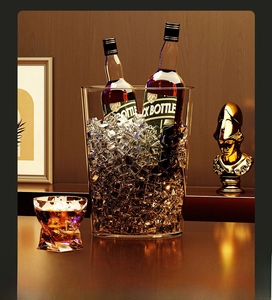 Close-up of a luxury transparent ice bucket holding wine bottles and ice cubes