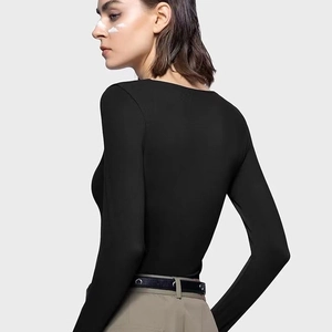 Slim fit black long sleeve square neck crop top shown from a side back view on a model