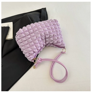 Close-up of purple bubble texture fabric and thin strap detail on the pleated shoulder bag