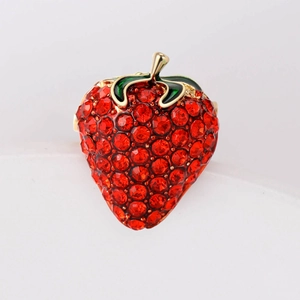 Sparkling strawberry brooch with red rhinestones and green enamel leaf on gold metal