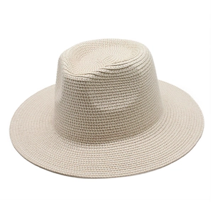 Close-up of beige woven straw Panama hat featuring fine texture and classic fedora crown